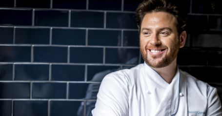 scott wearing a white chef jacket 